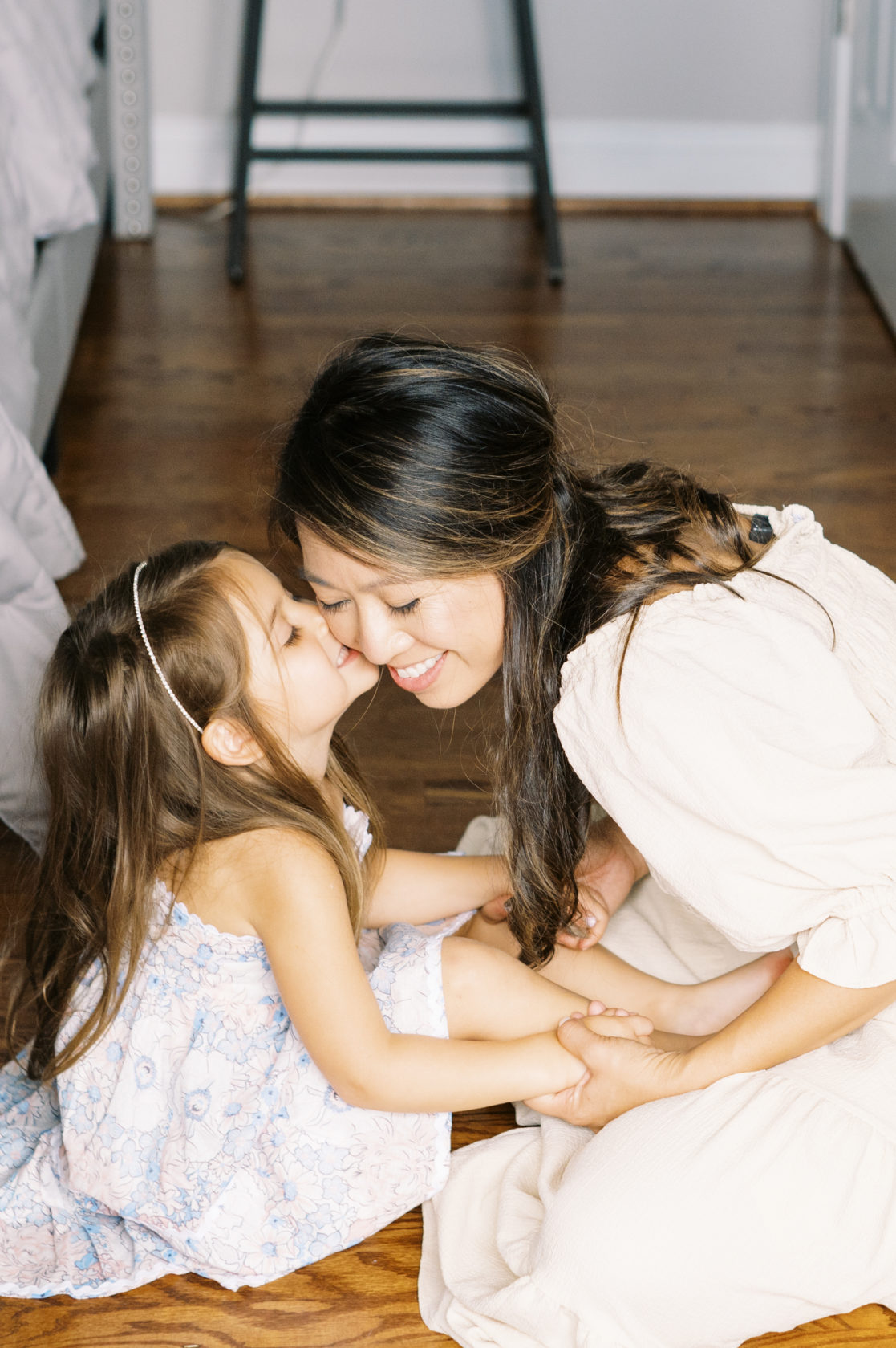 Photo of daughter giving mother a kiss on the cheek by Richmond family photographer Jacqueline Aimee Portraits