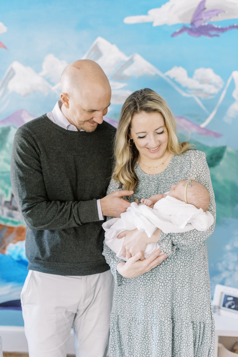 Richmond-newborn-photography 
 parents holding baby in fairy-tale-themed nursery