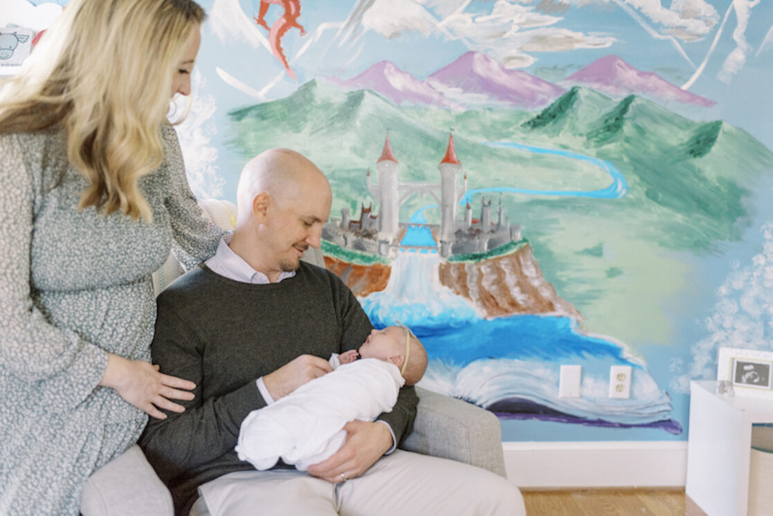 Richmond-newborn-photography parents holding baby in fairy-tale-themed nursery
