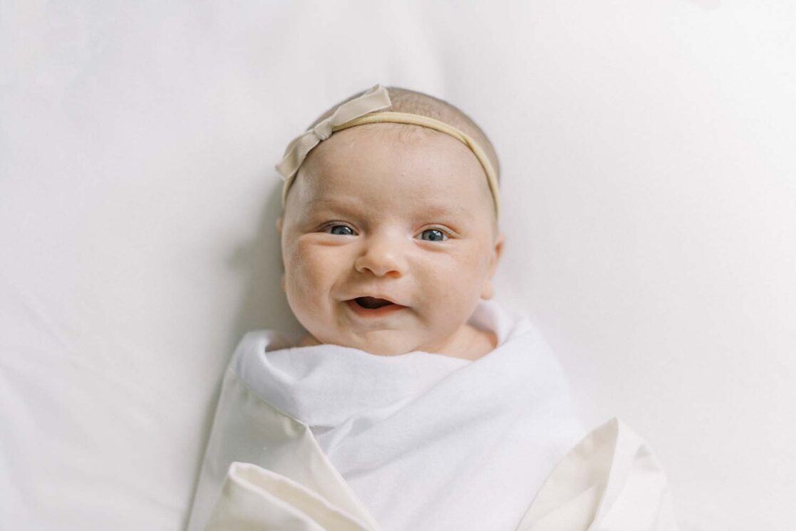 Photos of two month old baby smiling for her newborn photos 