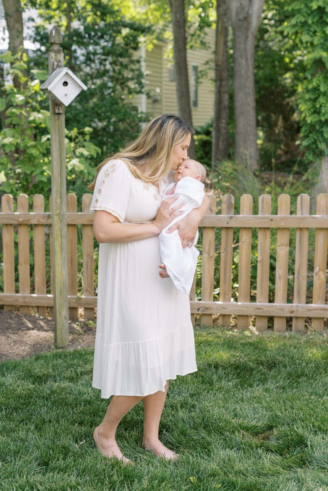 Photos of mom and dad with their two month old baby outside for her newborn photos 