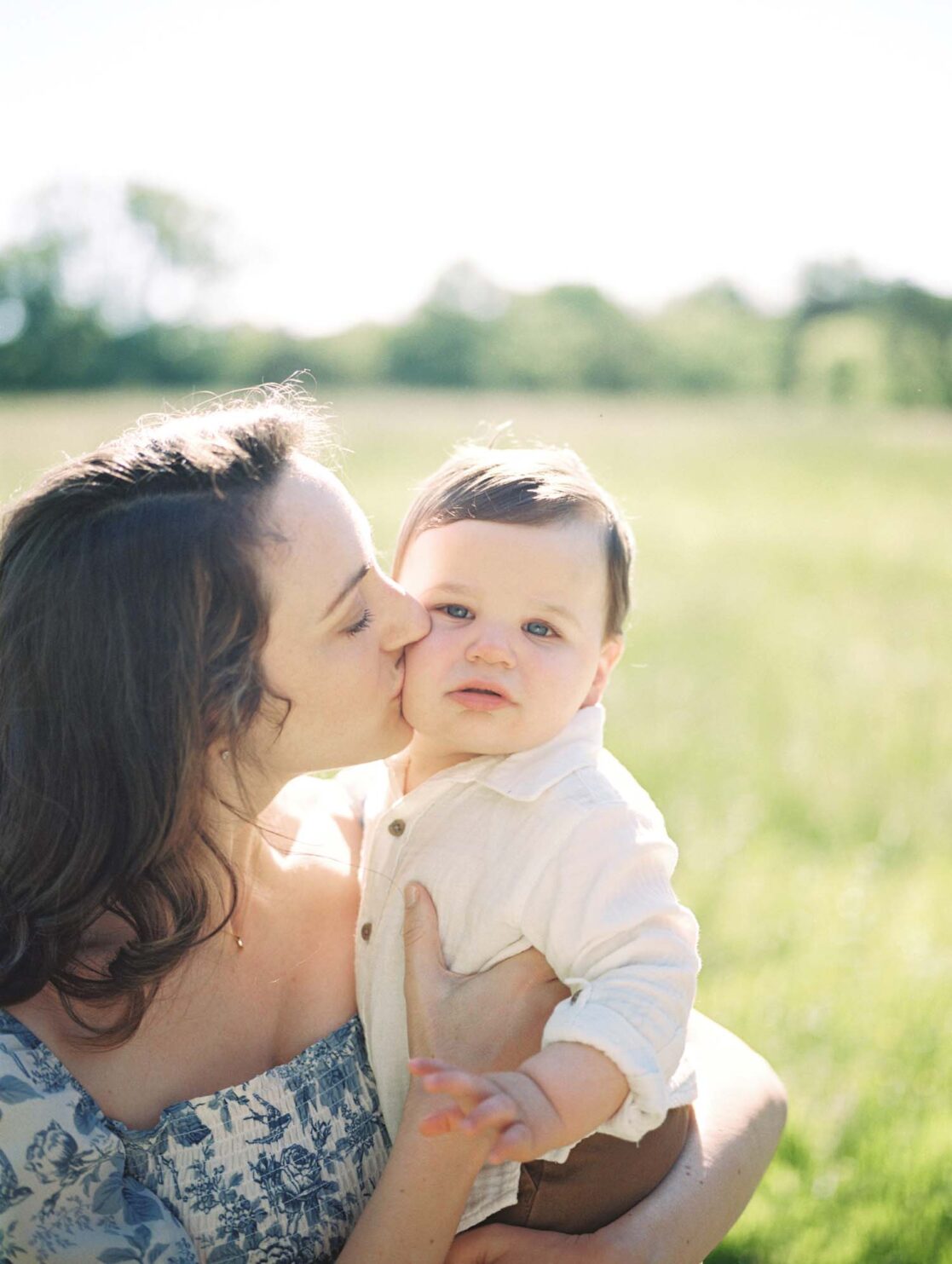 Photo of mom kissing baby son on his cheek by Richmond baby photographer Jacqueline Aimee Portraits
