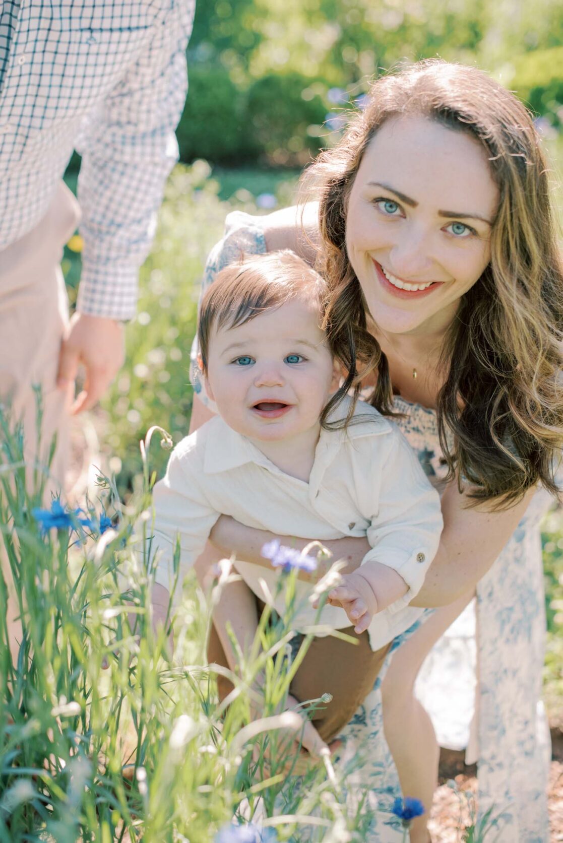 Photo of mom holding her baby son in a garden by Richmond baby photographer Jacqueline Aimee Portraits