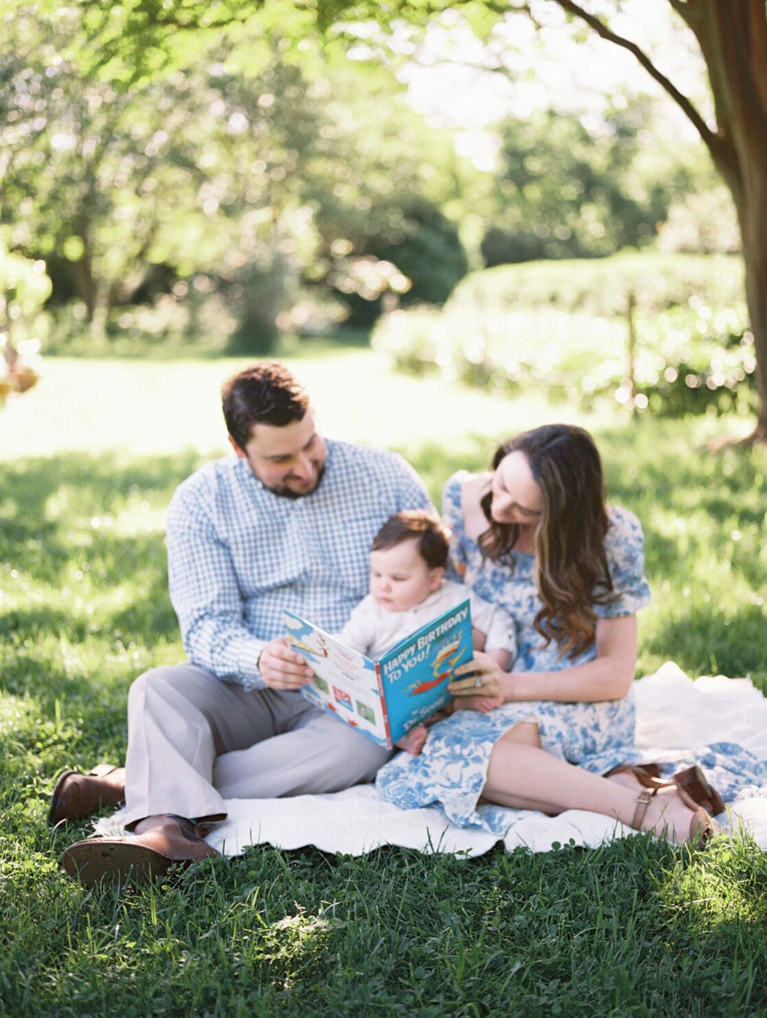 Photo of parents reading to one year old baby son by Richmond baby photographer Jacqueline Aimee Portraits