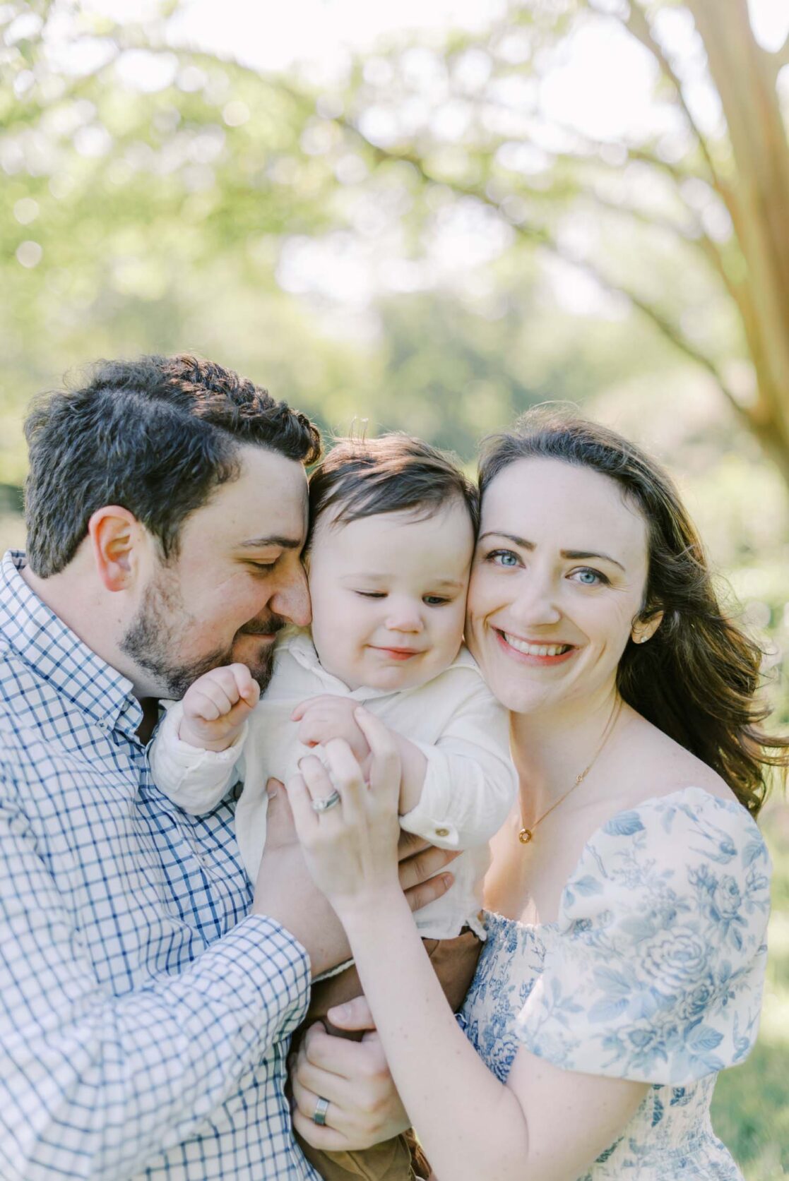 Photo of parents embracing their one year old baby son by Richmond baby photographer Jacqueline Aimee Portraits