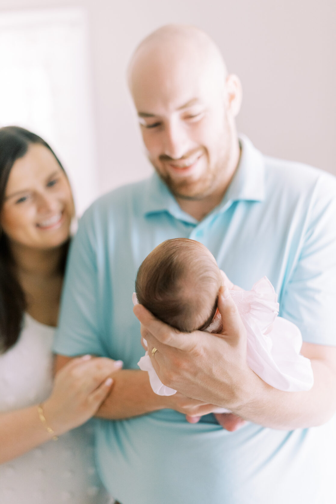parents holding newborn baby