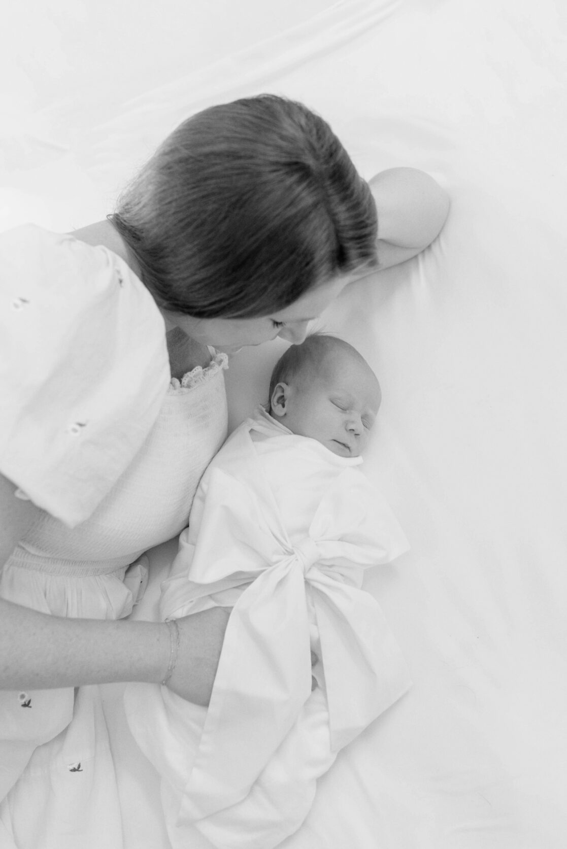 Key poses for newborn photos | Black and white light and airy photo of a mother looking at her her sleeping newborn baby by Richmond newborn photographer Jacqueline Aimee Portraits