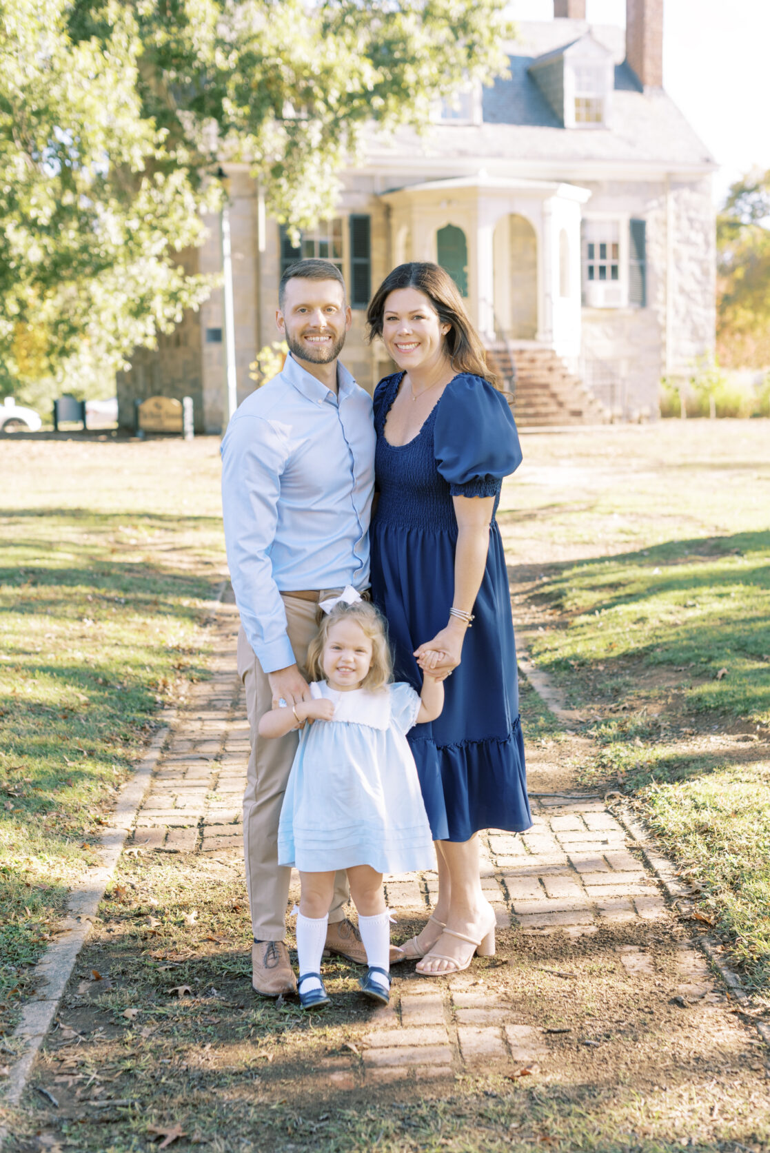 Photo of a family of three amongst the fall foliage during their richmond fall mini session with jacqueline aimee portraits