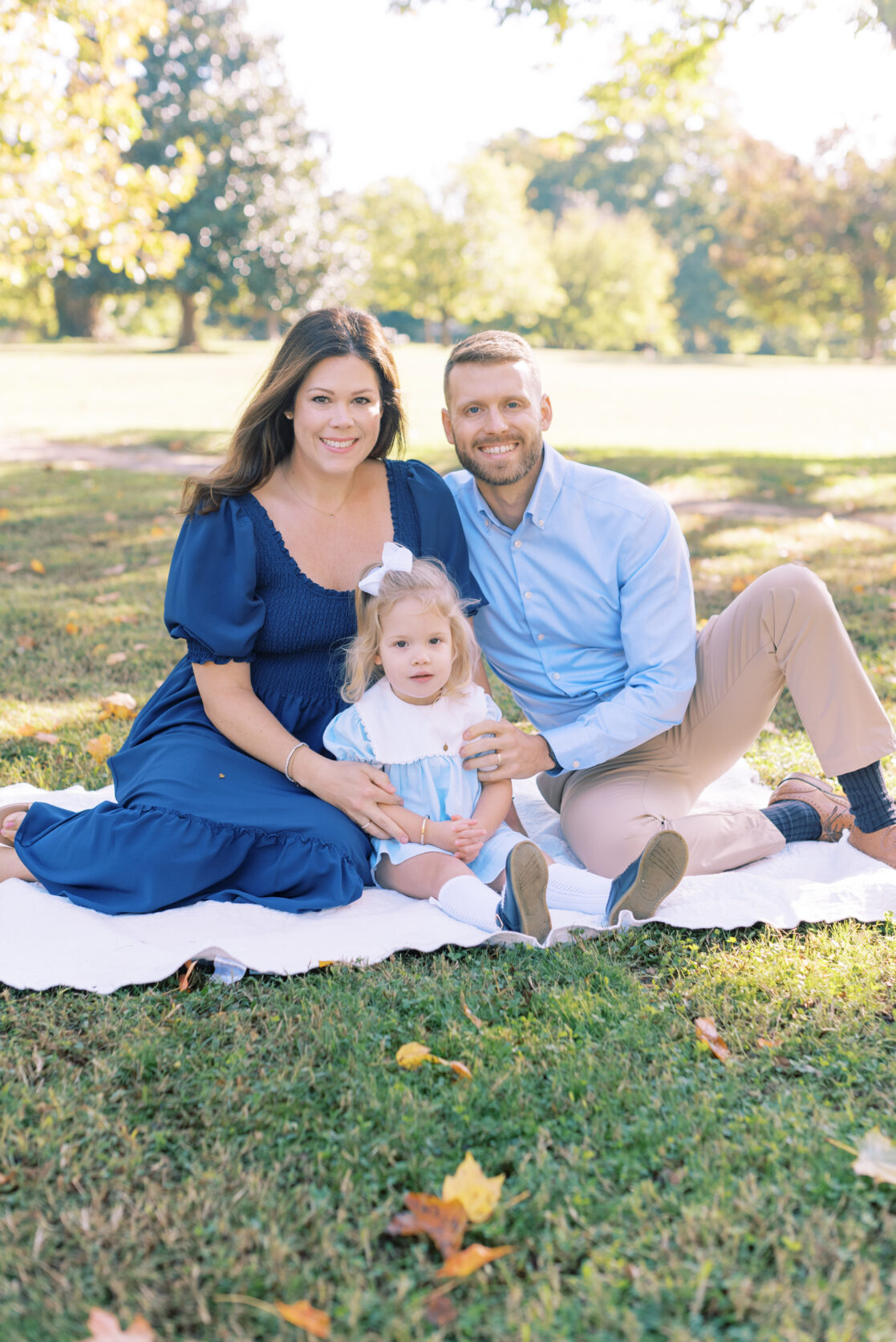 Photo of a family of three amongst the fall foliage during their richmond fall mini session with jacqueline aimee portraits