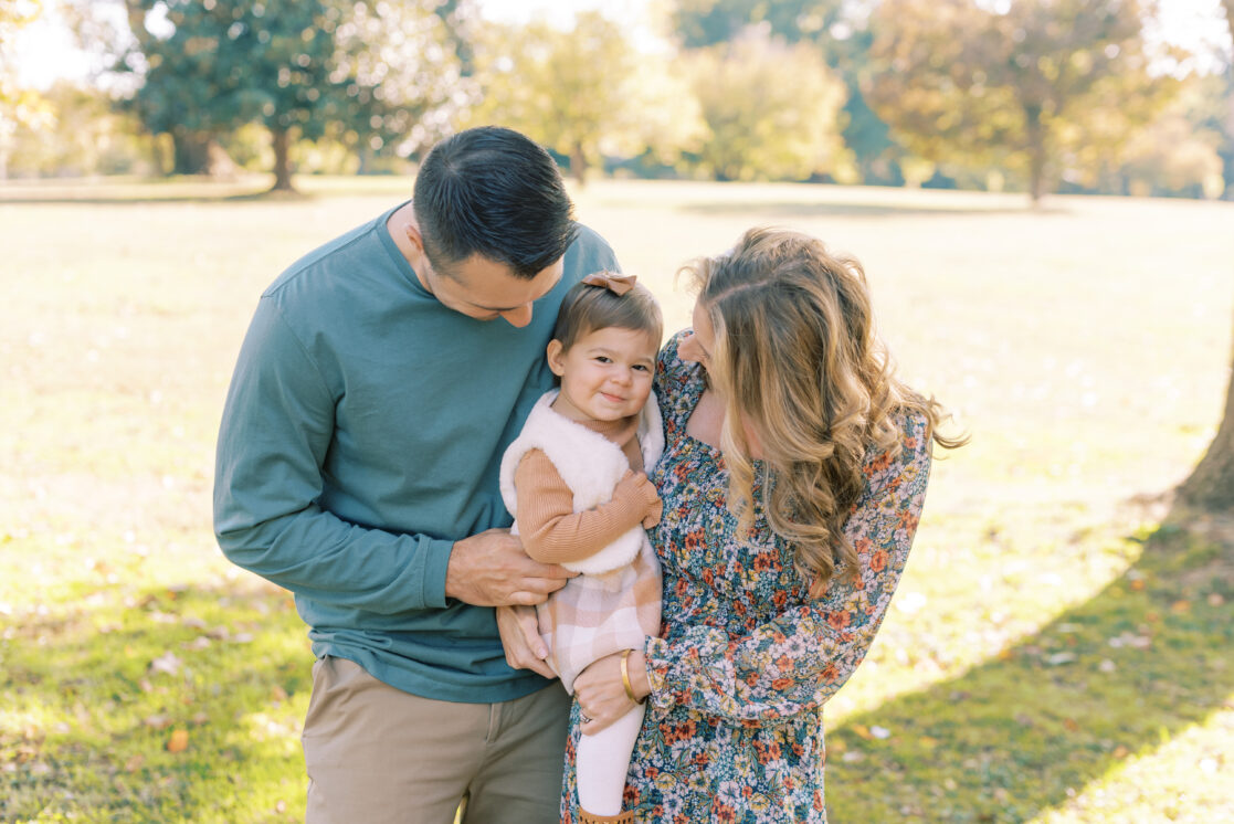 Photo of a family of three amongst the fall foliage during their richmond fall mini session with jacqueline aimee portraits