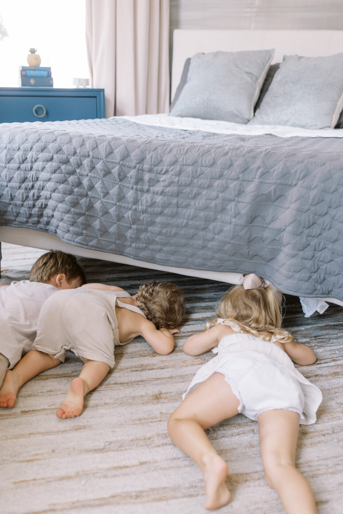 Three children peek under a bed during fun family photos in Richmond by Jacqueline Aimee Portraits 