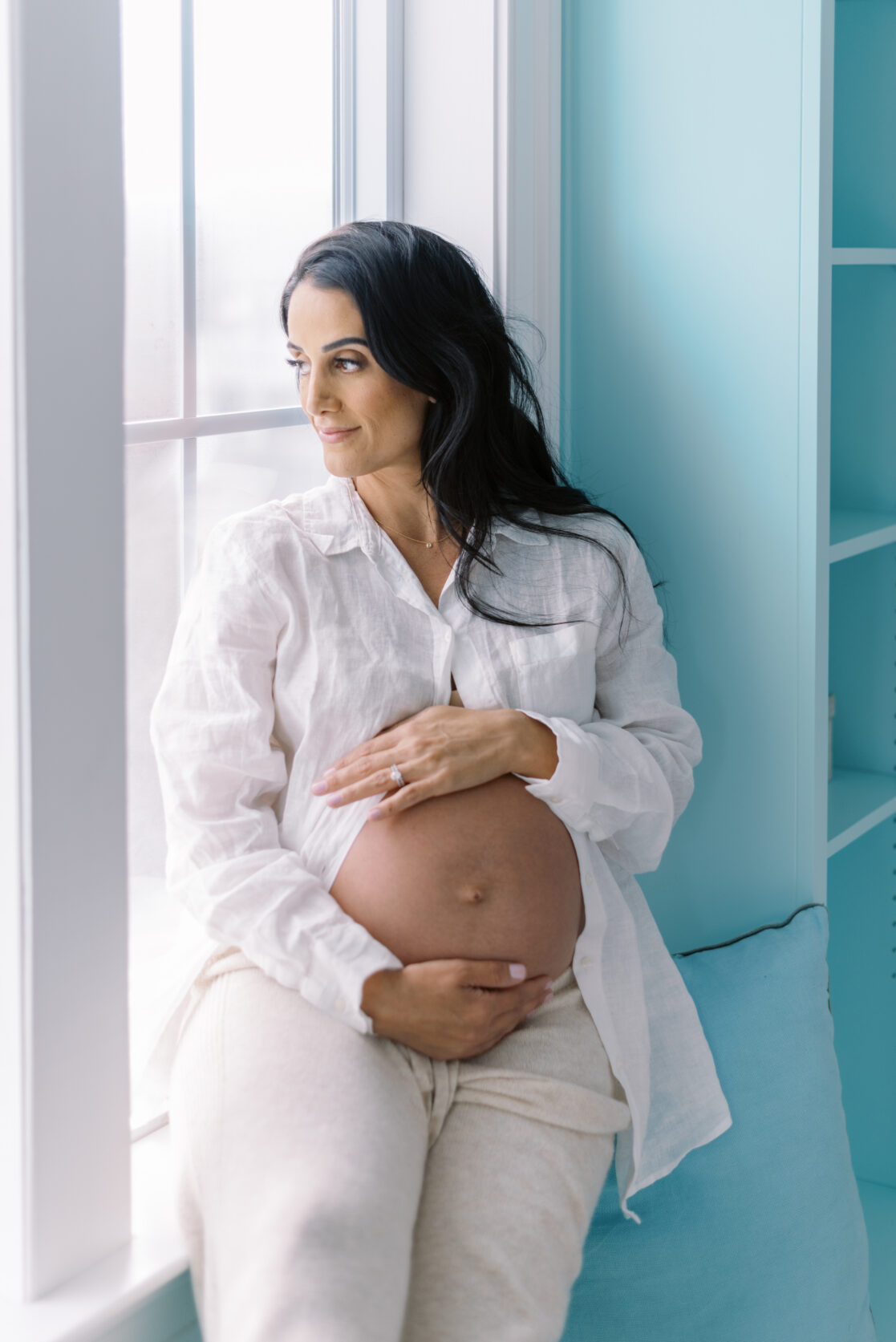 Richmond Birth Doula | Photo of a pregnant mom holding her belly and looking out the window by Richmond maternity photographer Jacqueline Aimee Portraits