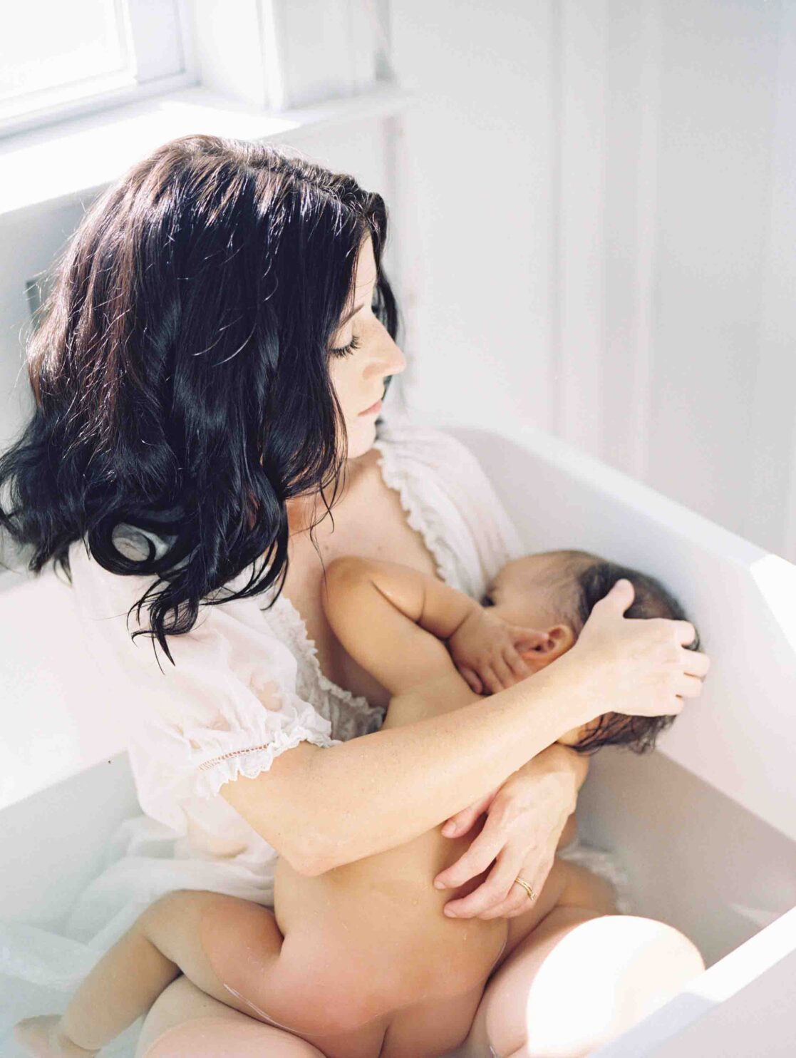 Expert pediatricians in Richmond | Film Photo of a mother breastfeeding her baby girl in a bathtub by Richmond newborn photographer Jacqueline Aimee Portraits