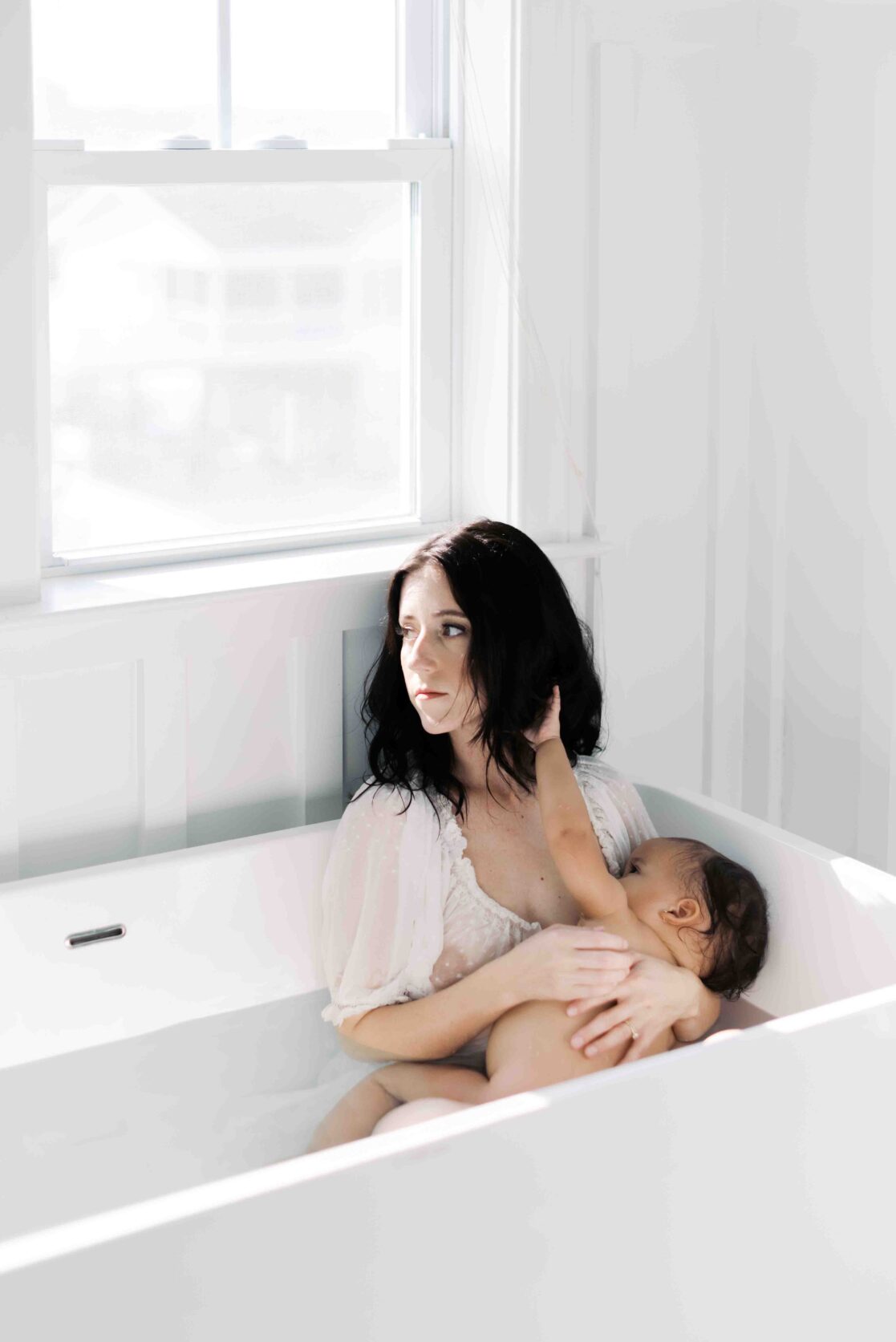 Expert pediatricians in Richmond | Film Photo of a mother breastfeeding her baby girl in a bathtub by Richmond newborn photographer Jacqueline Aimee Portraits