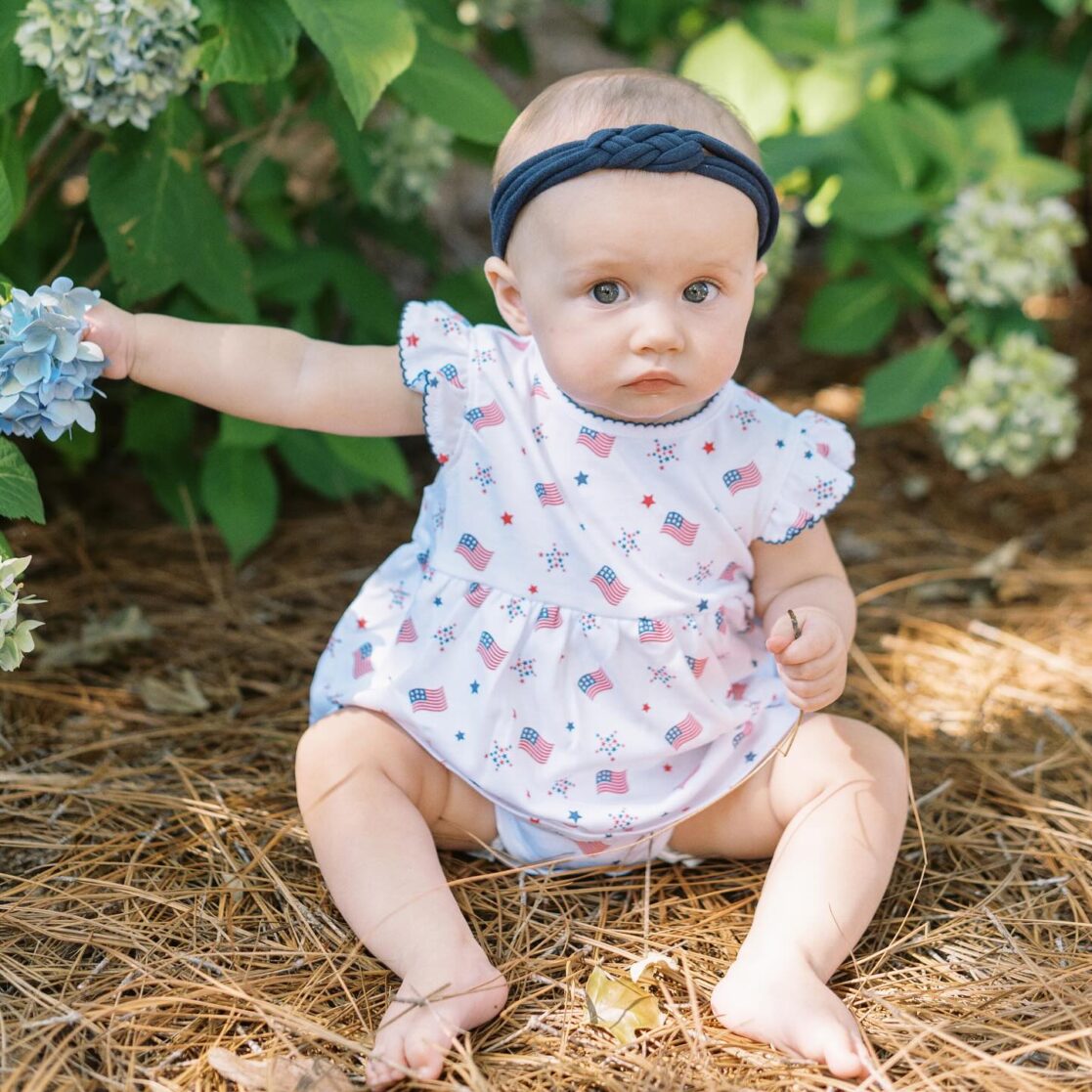 4th of July events in Richmond | Photo of a baby girl in patriotic clothes looking at the camera by Richmond family photographer Jacqueline Aimee Portraits