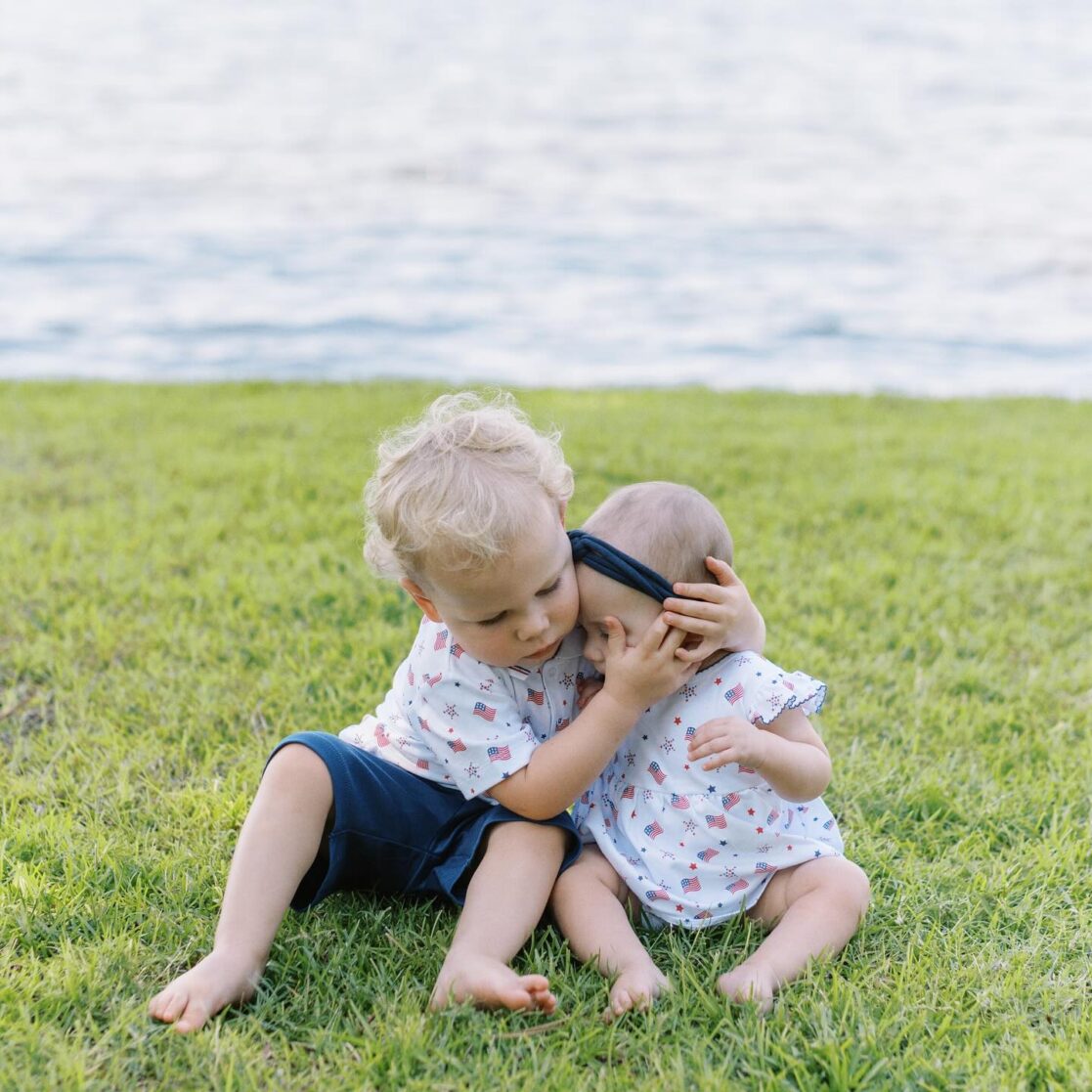 4th of July events in Richmond | Photo of a brother and sister in matching patriotic clothes hugging by the waterfront by Richmond family photographer Jacqueline Aimee Portraits
