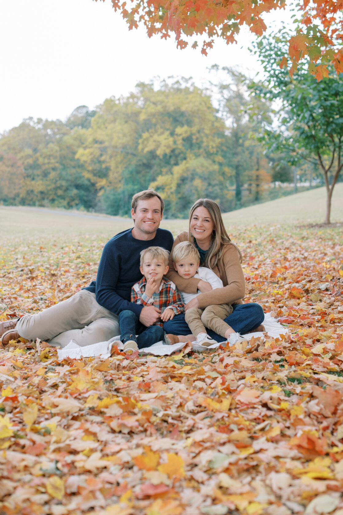 Richmond VA Fall Family Photos | a Family poses before golden, leaves in a Richmond park during autumn