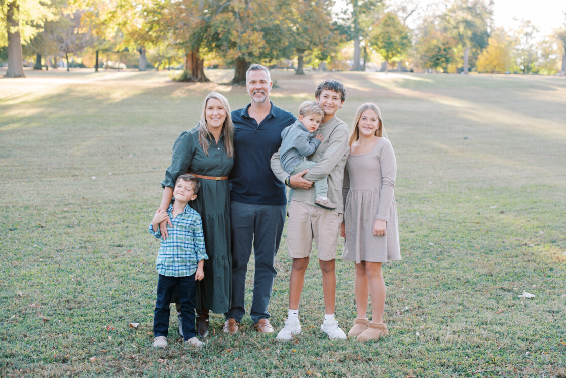 Richmond VA Fall Family Photos | a Family poses before golden, leaves in a Richmond park during autumn