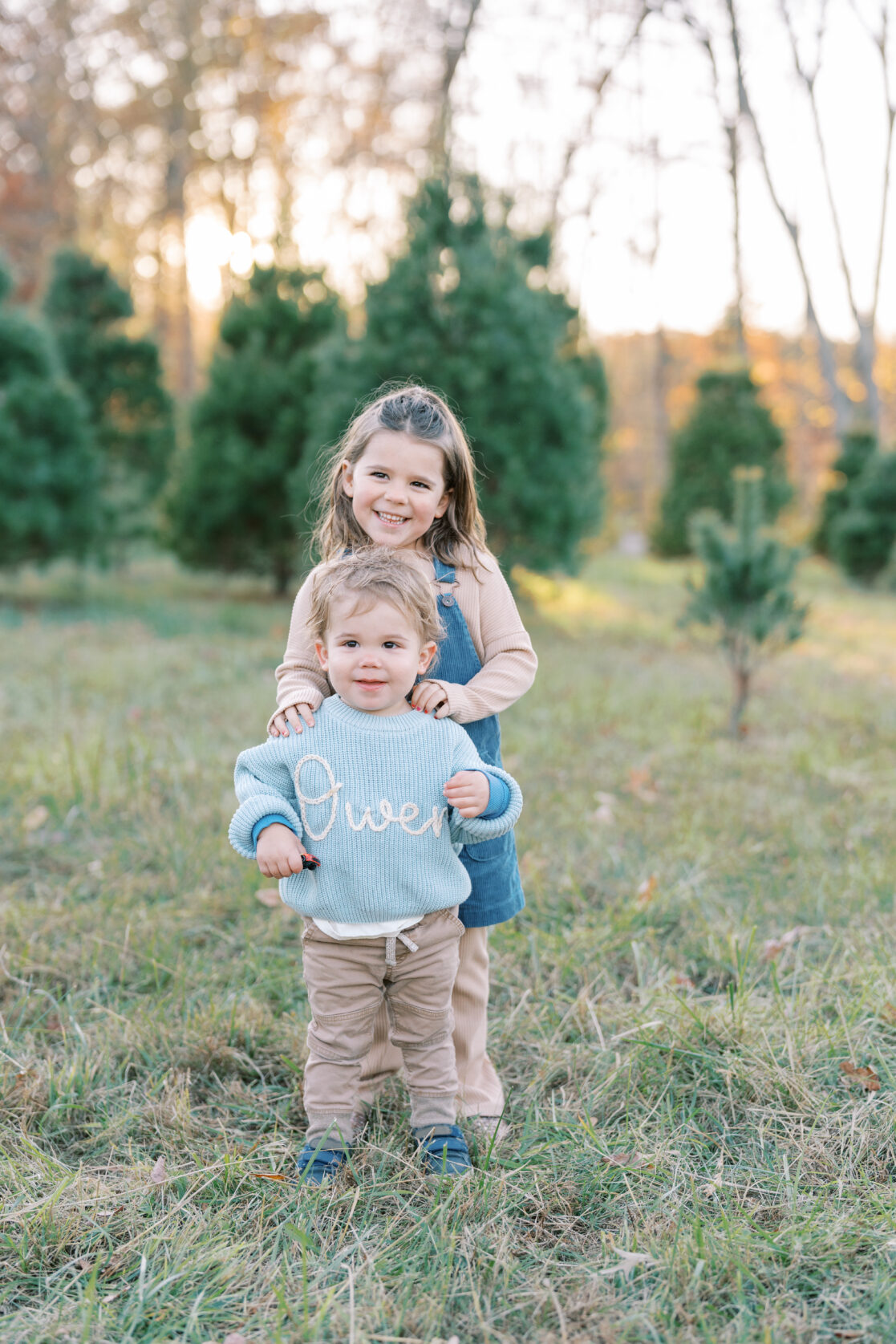 Holiday events for toddlers in Richmond, Virginia - Brother and sister pose together at a Christmas tree farm in Powhatan. 