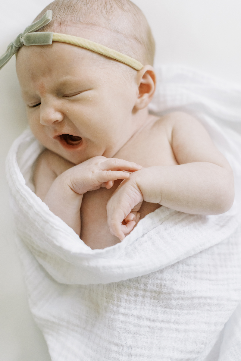 newborn baby posed yawning