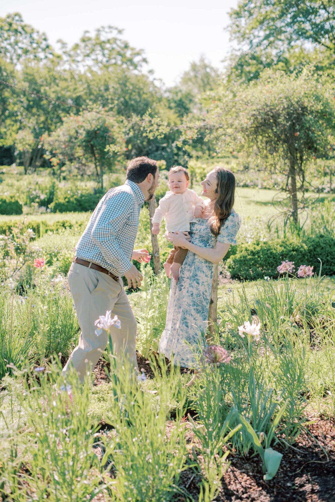 Photo of mom and dad playing with baby son in a garden by Richmond baby photographer Jacqueline Aimee Portraits