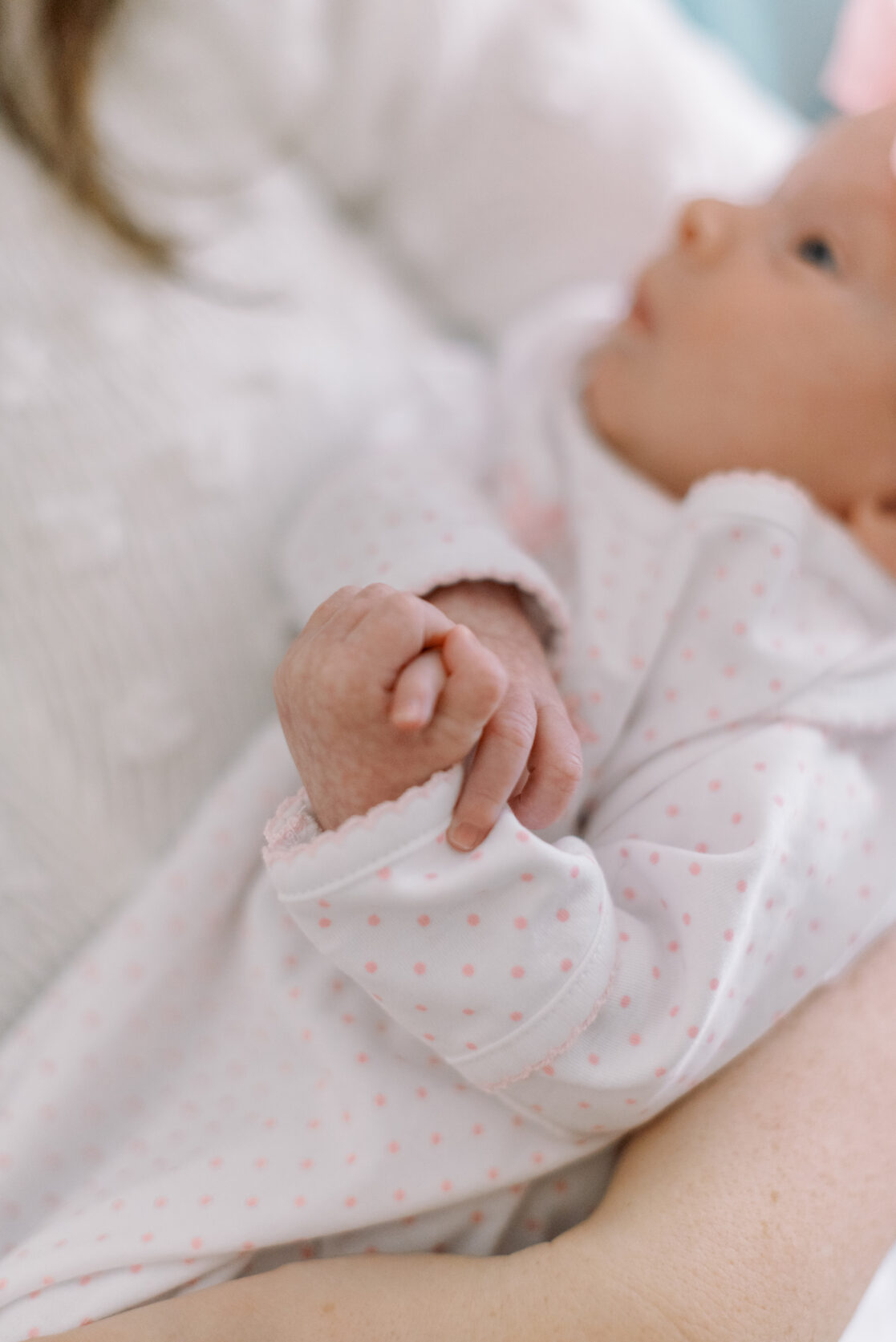 newborn clasping hands