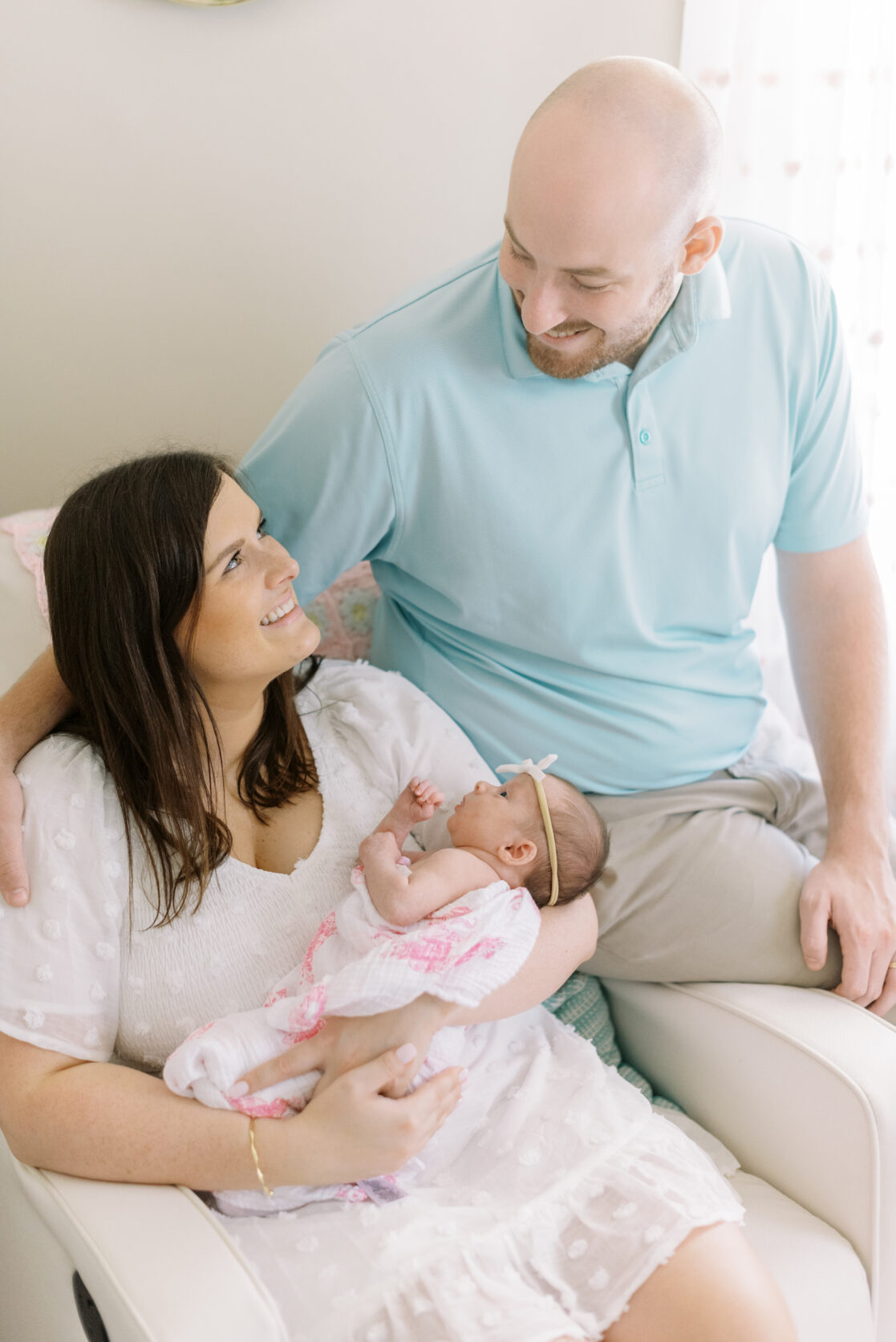 parents smiling holding baby